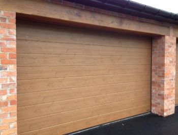 Hormann M rib automatic sectional garage door in Winchester Oak